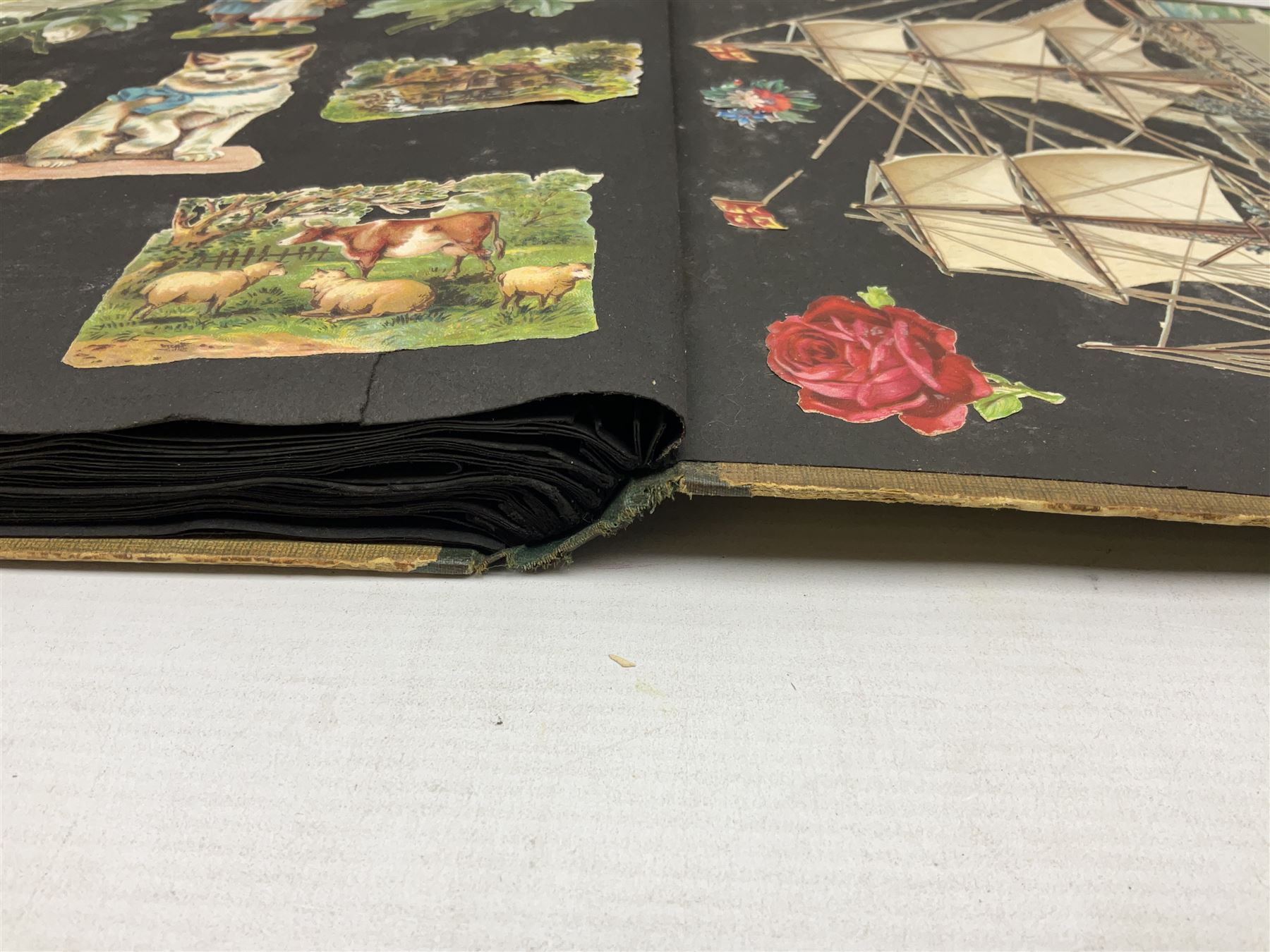 Victorian scrapbook containing twenty-six double sided pages and two fixed end pages of various fixed decoupage to include clippings of maritime interest, greeting cards, portraiture, flowers, animals etc, 