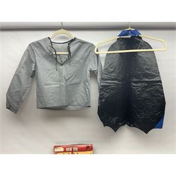 Two Boxed Batman Playsuit Costumes - 1960s 20th Century Original Play Suit, black eye mask, plastic vinyl cape/gauntlets, leather style belt, blue/yellow shirt, with Bat motif and blue/yellow pants; in original illustrated lidded box; and 1976 Decker Batman Playsuit costume, vinyl cape/ mask/gloves/boot tops/yellow belt, grey cloth top and pants; in original illustrated box (2)