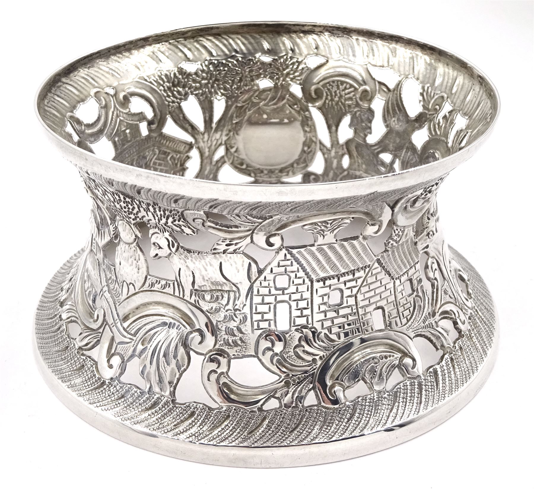 Edwardian Irish silver dish ring, of circular waisted form, embossed and pierced throughout with scene of figures, birds, cattle and buildings amidst C scrolls, hallmarked James Wakely & Frank Clarke Wheeler, Dublin 1906, upper rim D10cm, approximate weight 4.11 ozt (128 grams)