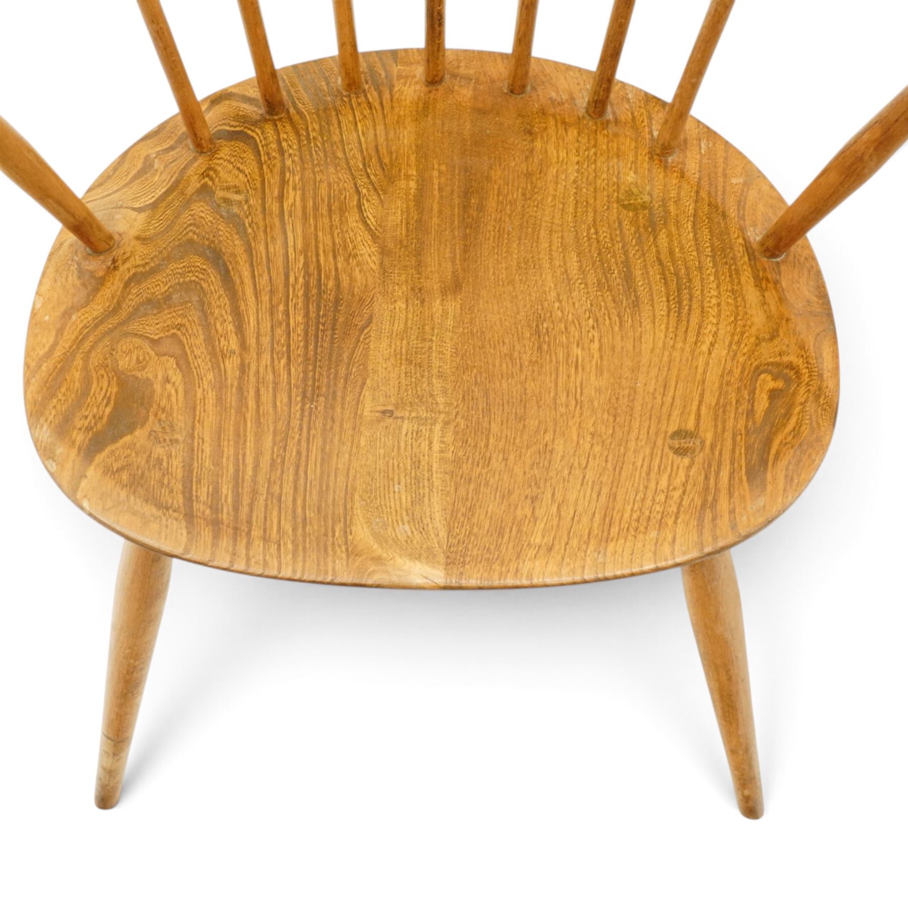 Ercol - pair of 'Cowhorn' elm carver chairs, curved back raised on nine stretchers, elm dished seats, raised on tapering supports