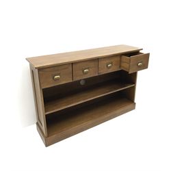 Oak sideboard, projecting top, four drawers, single shelf on platform base 