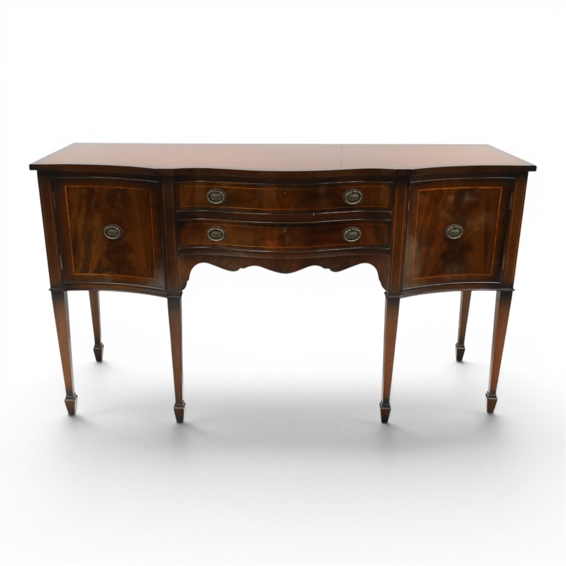 Georgian design mahogany serpentine sideboard, shaped top over two central drawers flanked by cupboard doors, flame mahogany veneered fronts with satinwood stringing, oval brass handles, shaped apron, on square tapering supports with spade feet