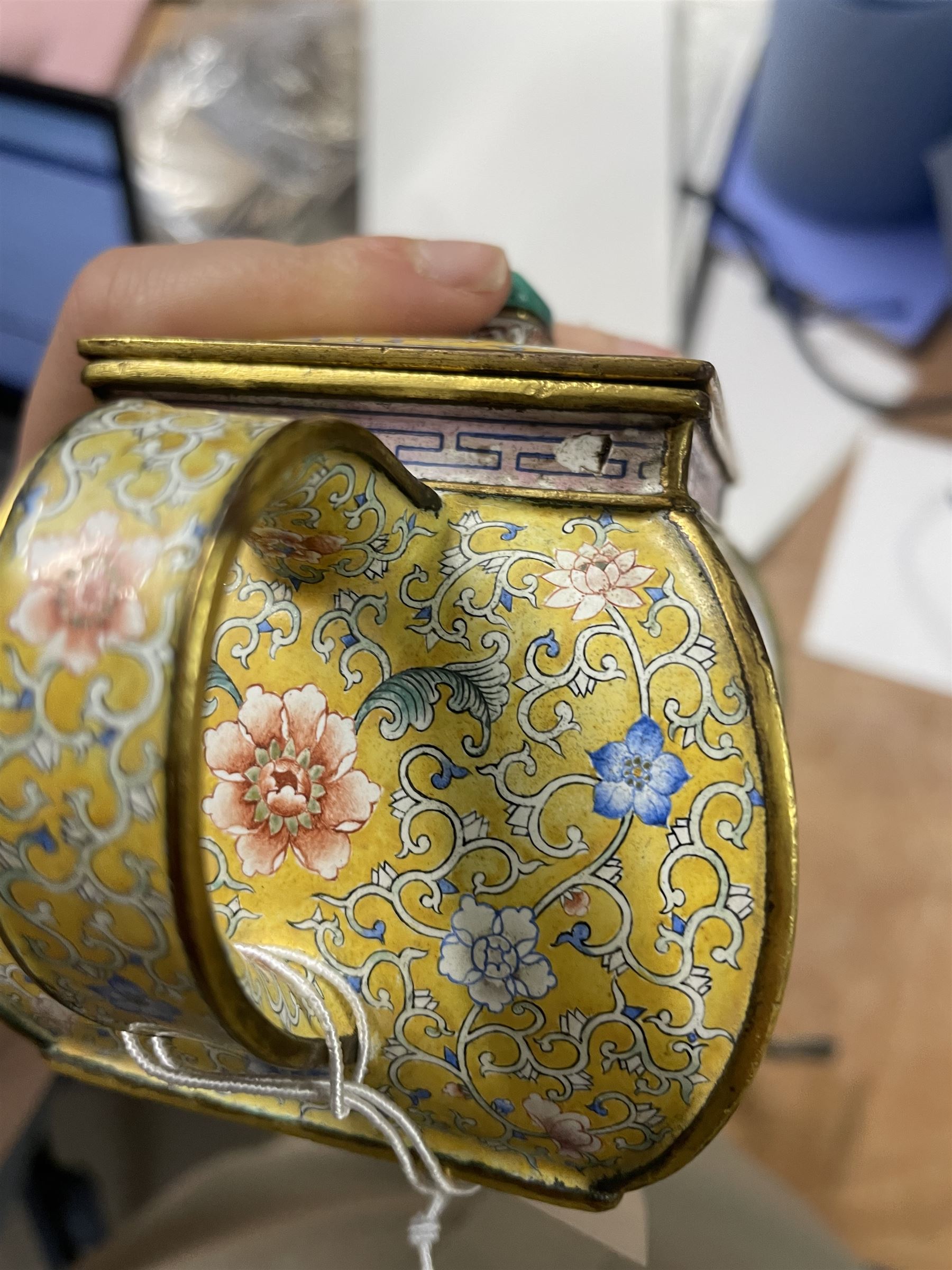 Chinese Qianlong enamel bombé shaped teapot, decorated with scenes of scholars examining a scroll and drinking on a yellow ground with various traditional floral and foliate motifs, the painted scene framed within trailing blue vine border, with Qianlong marks to base L15cm