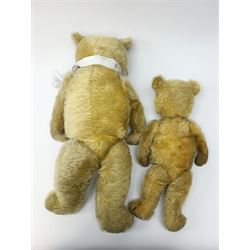 Two 1930s Chiltern type graduated teddy bears, one wood wool and one wood wool and kapok filled plush bodies, each with swivel revolving head, applied eyes and vertically stitched nose and mouth and jointed limbs, tallest H20.5