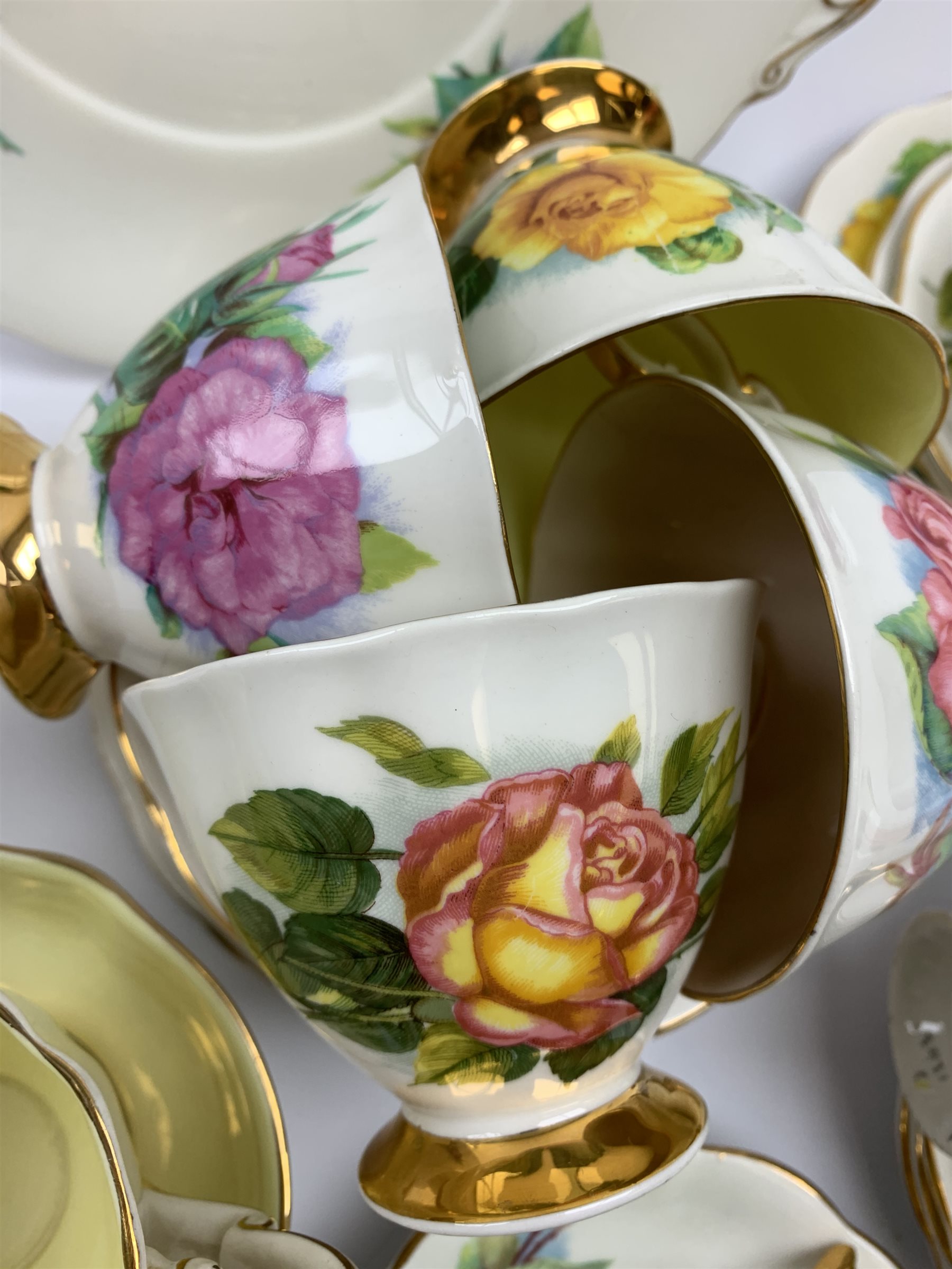 Royal Standard Harry Wheatcroft 'World Famous Roses' tea and coffee wares, comprising teapot, six teacups and six saucers, six coffee cups and five saucers, six side plates, milk jug, cream jug, two open sucriers, and sandwich plate. 