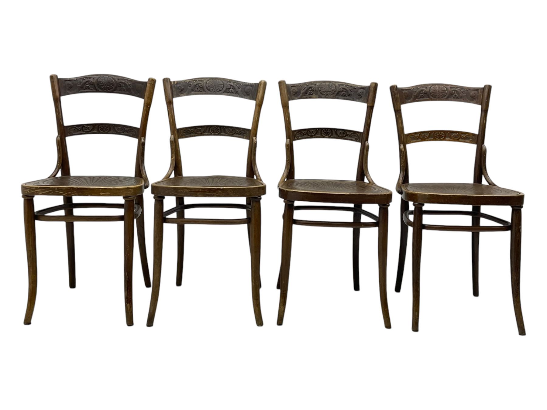 Jacob & Josef Kohn - set of four early 20th century Austrian bentwood chairs, each with carved decoration to the shaped backrest and shaped seat, on splayed supports with stretchers, marked with the manufacturer's stamp and paper label beneath