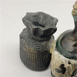 Bronze figure of a seated man resting on a sack