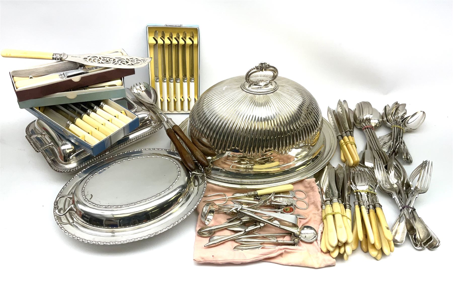 A silver plated part fluted meat dome with beaded rim, and unassociated Mappin & Webb base, together with two silver plated serving dishes and covers, one with oblique gadrooned detail, plus a quantity of mostly silver plated and ivory handled flatware. 