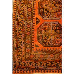 Persian Bokhara rust ground rug, decorated with triple Gul medallions, 82cm x 140cm  