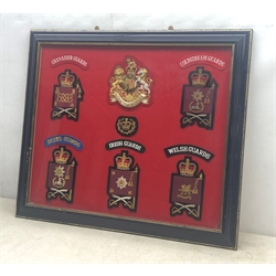  Collection of Coldstream, Grenadier, Scots, Irish & Welsh Guards shoulder and arm embroidered badges including Warrant Officer, framed, 46cm x 54cm   