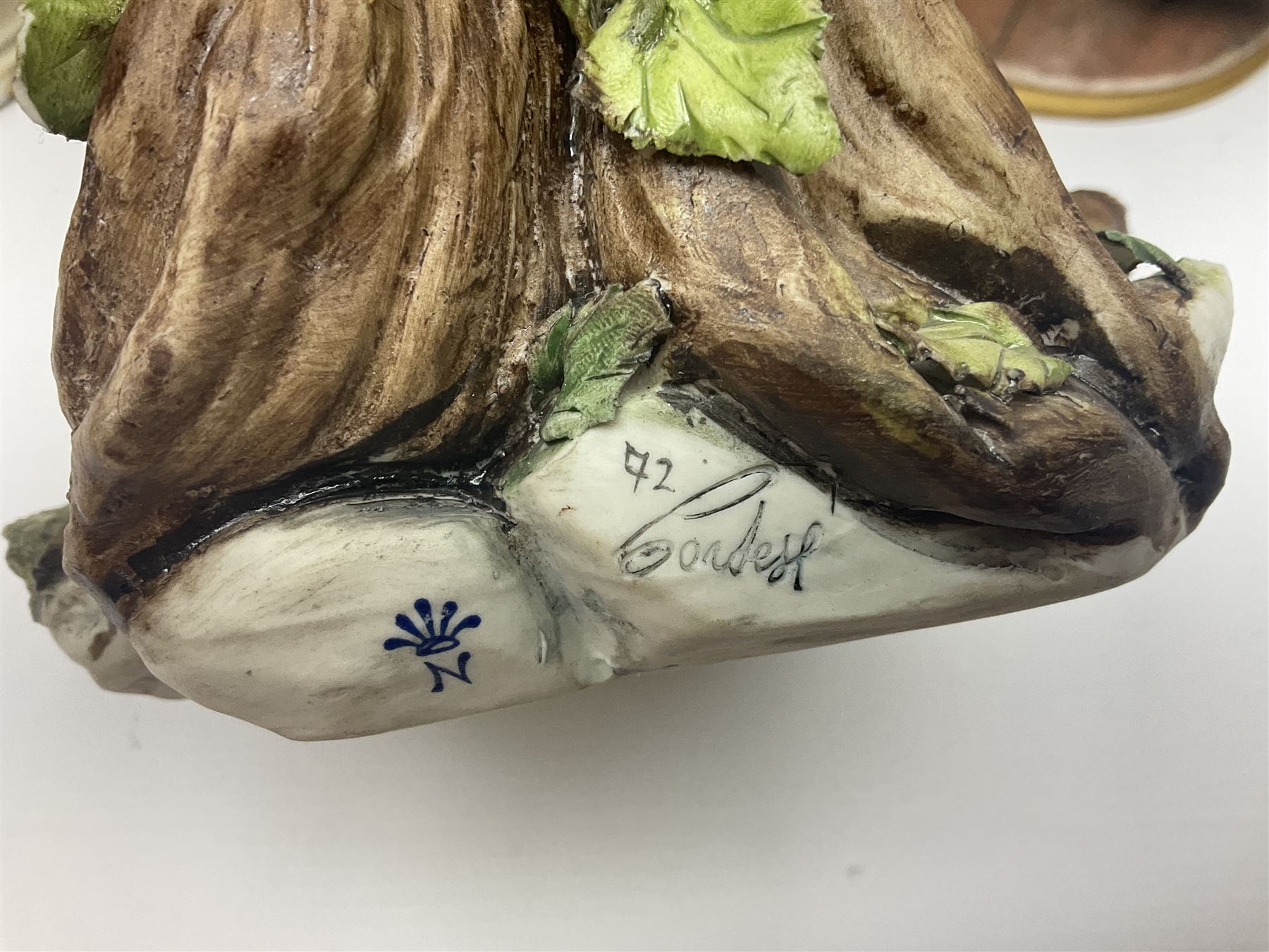 Three Capodimonte figures, to include The Kind Heart Man, modelled by Cortese as a tramp with two doves, The Young Falconer by Maria Angela and another modelled as a tramp darning his socks, all with printed marks, tallest H39cm