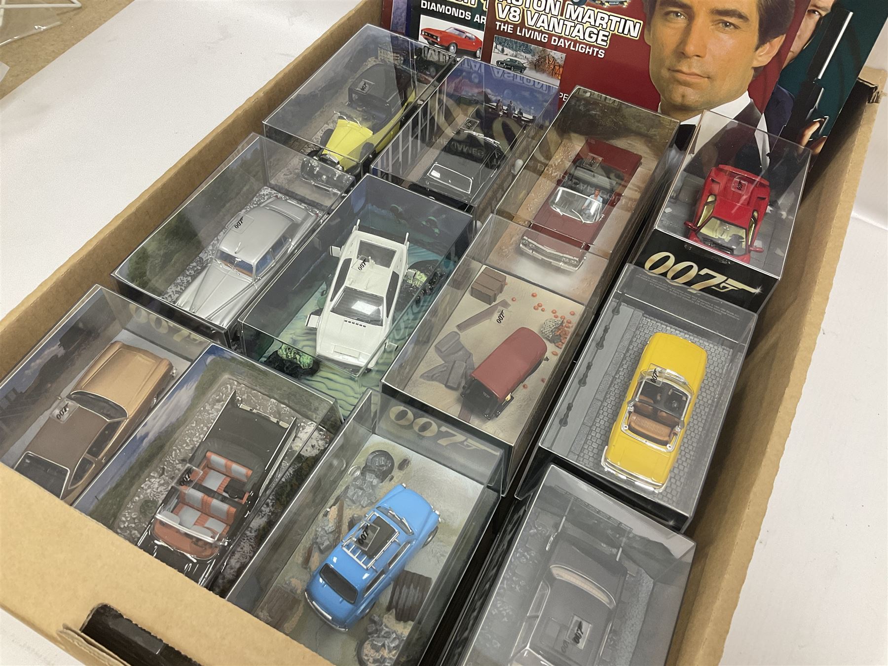 Fabbri James Bond Collection - over one hundred and ten die-cast models in perspex display cases as issued periodically; and a quantity of associated magazines and trading cards, in five boxes