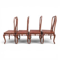 20th century Chinese ornately hardwood dining table and chairs, circular table with 'Lazy Susan' top with pierced carved frieze, raised on a quadriform base with carved foliate detail, the chairs en suite with carved pierced detailing  