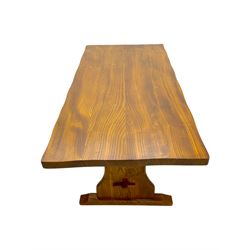 Late 20th century oak trestle table, rectangular top with naturalistic edge, supported by two curved pedestal bases united by central stretcher, on block feet