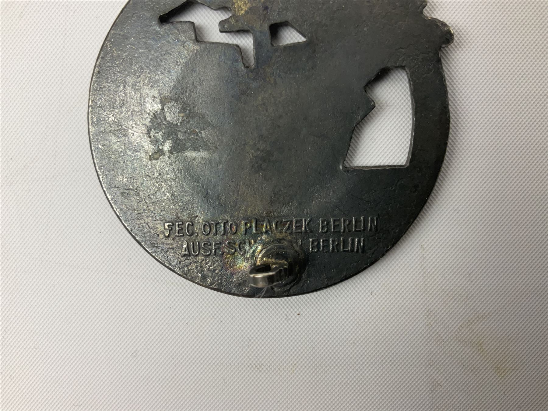 Three WW2 German badges comprising Blockade Runner War Badge and Coastal Artillery badge, both marked 'Fec Otto Placzec Berlin'; and Infantry Assault Badge; all with fixing pins (3)