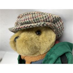 Lakeland Bears teddy bear, titled 'Walkright', dressed as a hiker in green corduroy duffle coat over fair isle jumper, trousers and knit socks, complete with leather clogs with wood soles, walkers thumb stick, knitted scarf, flat cap and rucksack housing original tag and map, H50cm