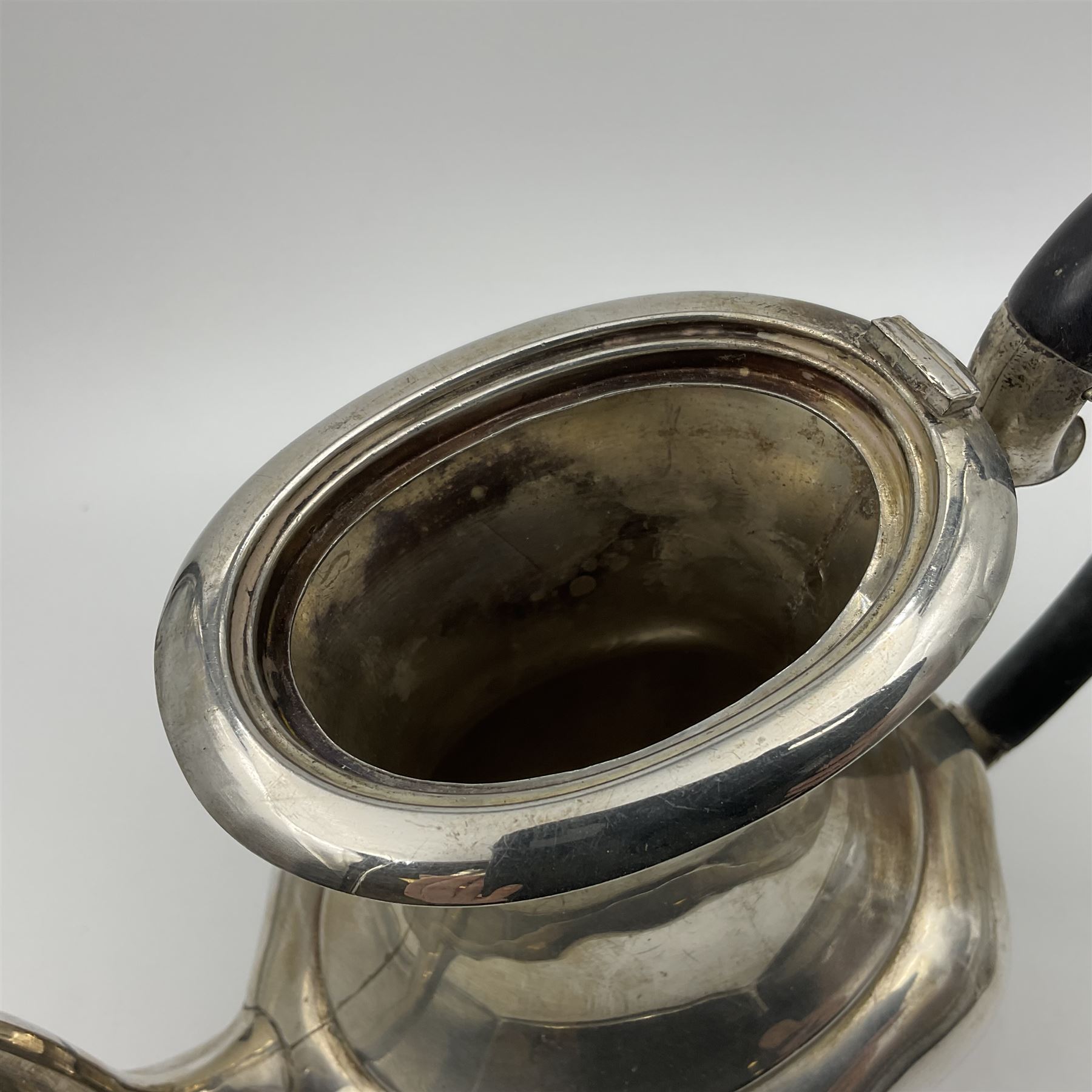 Five piece Edwardian silver tea service, comprising teapot and coffee pot, each with ebonised scroll handle, tea caddy with hinged cover, twin handled open sucrier, and milk jug, each of rounded bombe form, upon four paw feet, hallmarked William Adams Ltd, Birmingham 1904 and 1905, coffee pot H26cm
