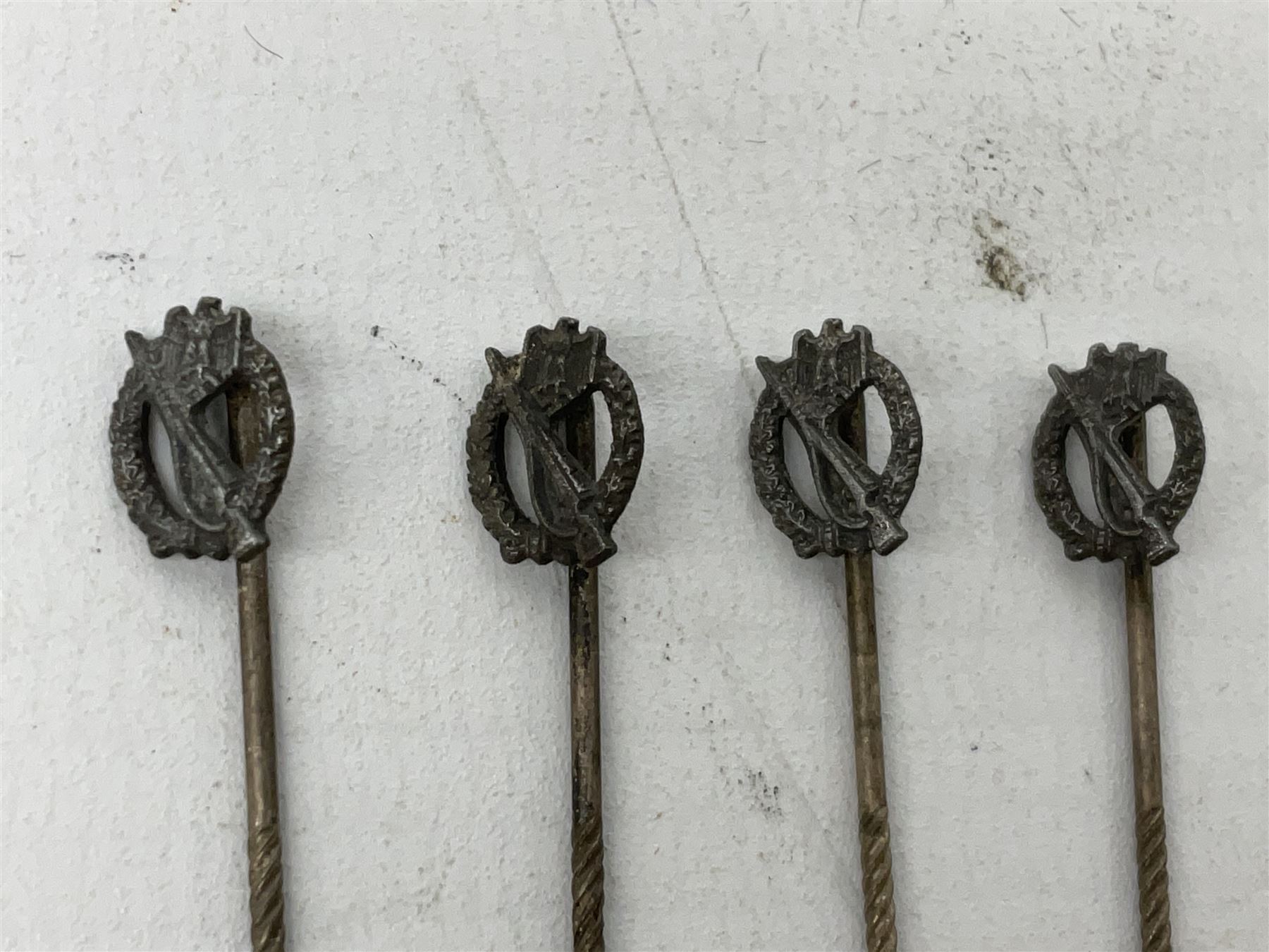 Nine WW2 German lapel pins including five Infantry Assault, Tank Assault etc 