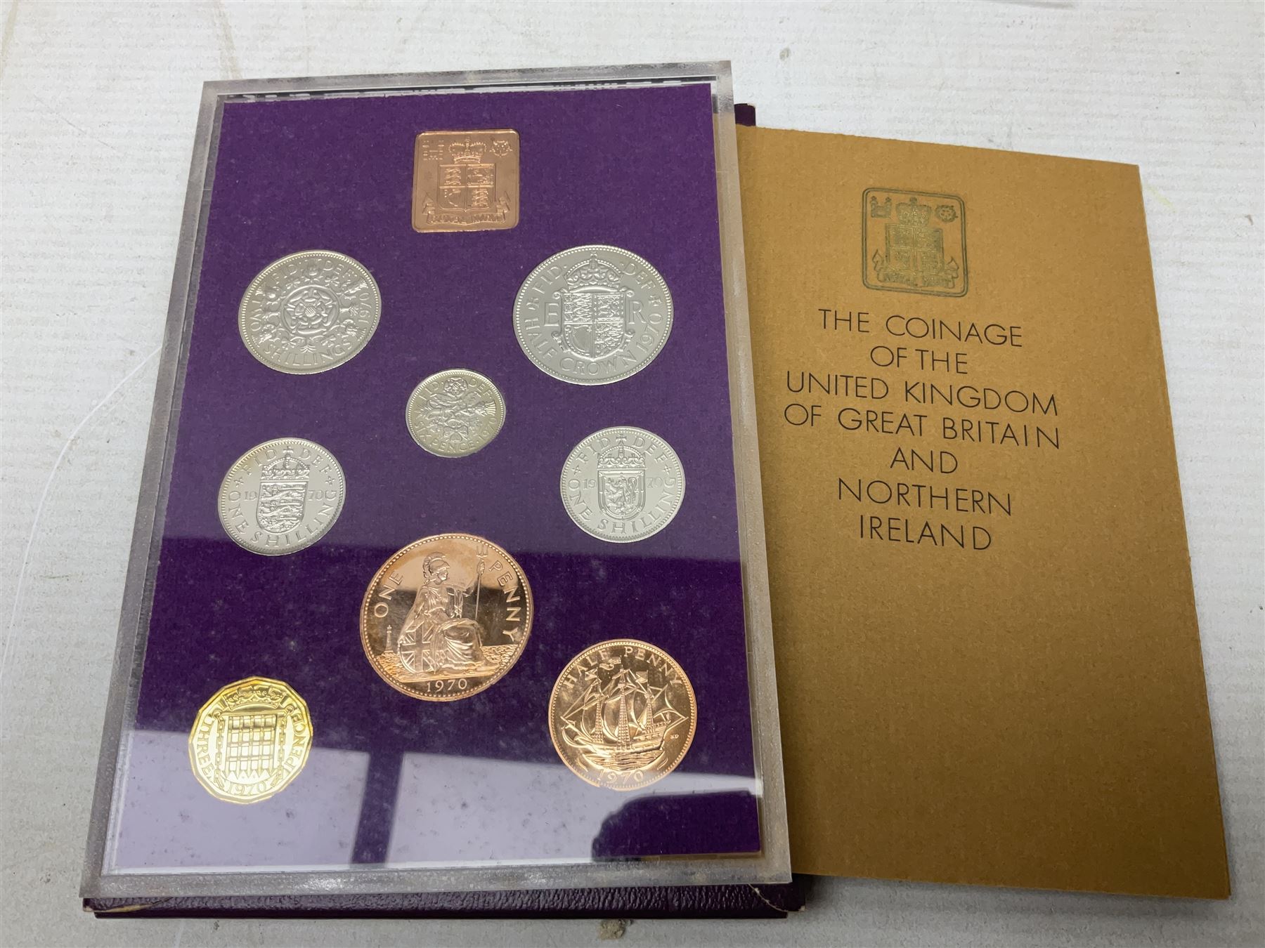 Coins and sets, including Great Britain and Northern Ireland 1970 proof coin collection in card folder, Queen Elizabeth II 2021 'Through the Looking Glass' five pounds, 2021 'Winnie the Pooh' fifty pence, Queen Victoria 1887 halfcrown, King George V 1914 halfcrown, commemorative coins, The Royal Mint Solomon Islands 2003 twenty-five dollars silver proof coin cased with certificate, 9ct gold half sovereign mount etc