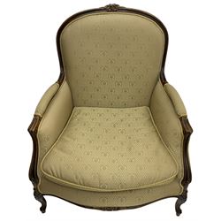 French design walnut framed armchair, arched moulded cresting rail carved with flower heads, upholstered in pale olive green with repeating pattern, scroll carved arm supports terminating to cabriole feet carved with flower heads