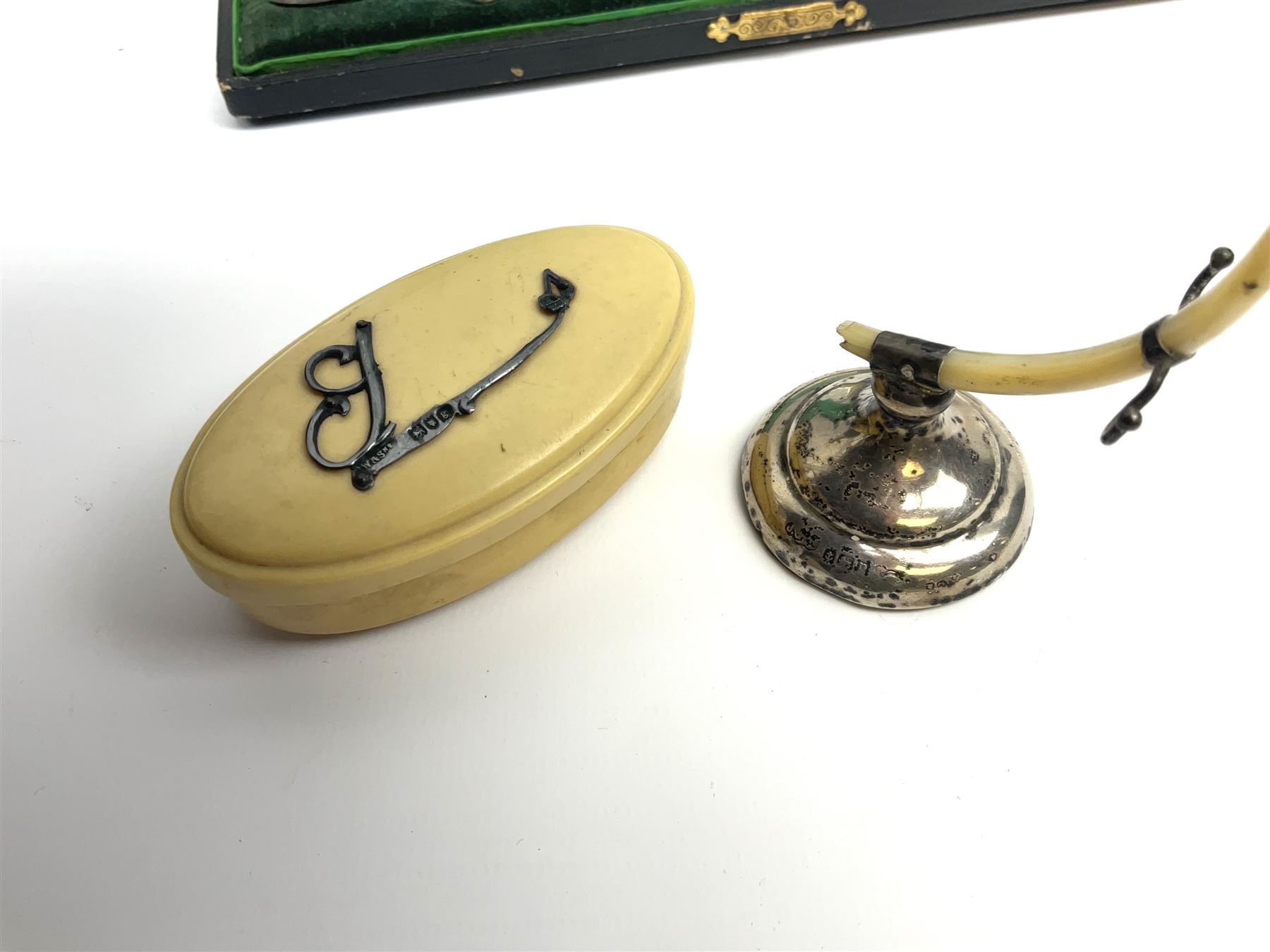 Cased silver handled glove stretcher, button hook, shoe horn, etc., hallmarked Adie & Lovekin Ltd, Chester 1911, and Adie & Lovekin Ltd, Birmingham 1911, miniature silver mounted hymn book, the cover embossed with cherubs, silver handled button hook, ivory handled button hook with silver ferrule, two silver dressing table pot lids, etc. 