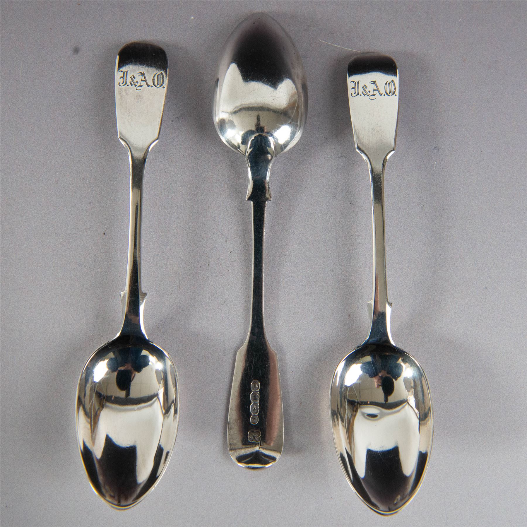 Set of twelve Victorian Exeter silver Fiddle pattern teaspoons, all with engraved initials to terminal, hallmarked Josiah Williams & Co, Exeter 1860, contained within tooled leather case with burgundy silk and velvet lined interior
