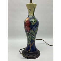 Moorcroft Simeon pattern table lamp base of slim baluster upon a turned wooden base, H42cm