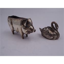 Edwardian silver novelty pin cushion, modelled as a pig with cushioned back, hallmarked Henry Matthews, Birmingham 1908, L9cm, together with a further 20th century silver novelty pin cushion, modelled as a swan with cushioned back, hallmarked Birmingham, date letter and makers mark worn and indistinct, and a small group of silver, to include 1920's souvenir coffee spoon with enamel terminal, hallmarked Robert Chandler, Birmingham 1924, pair of Victorian Onslow pattern salt spoons, hallmarked Thomas Bradbury & Sons, London 1893, etc., approximate gross weight 2.98 ozt (92.7 grams)
