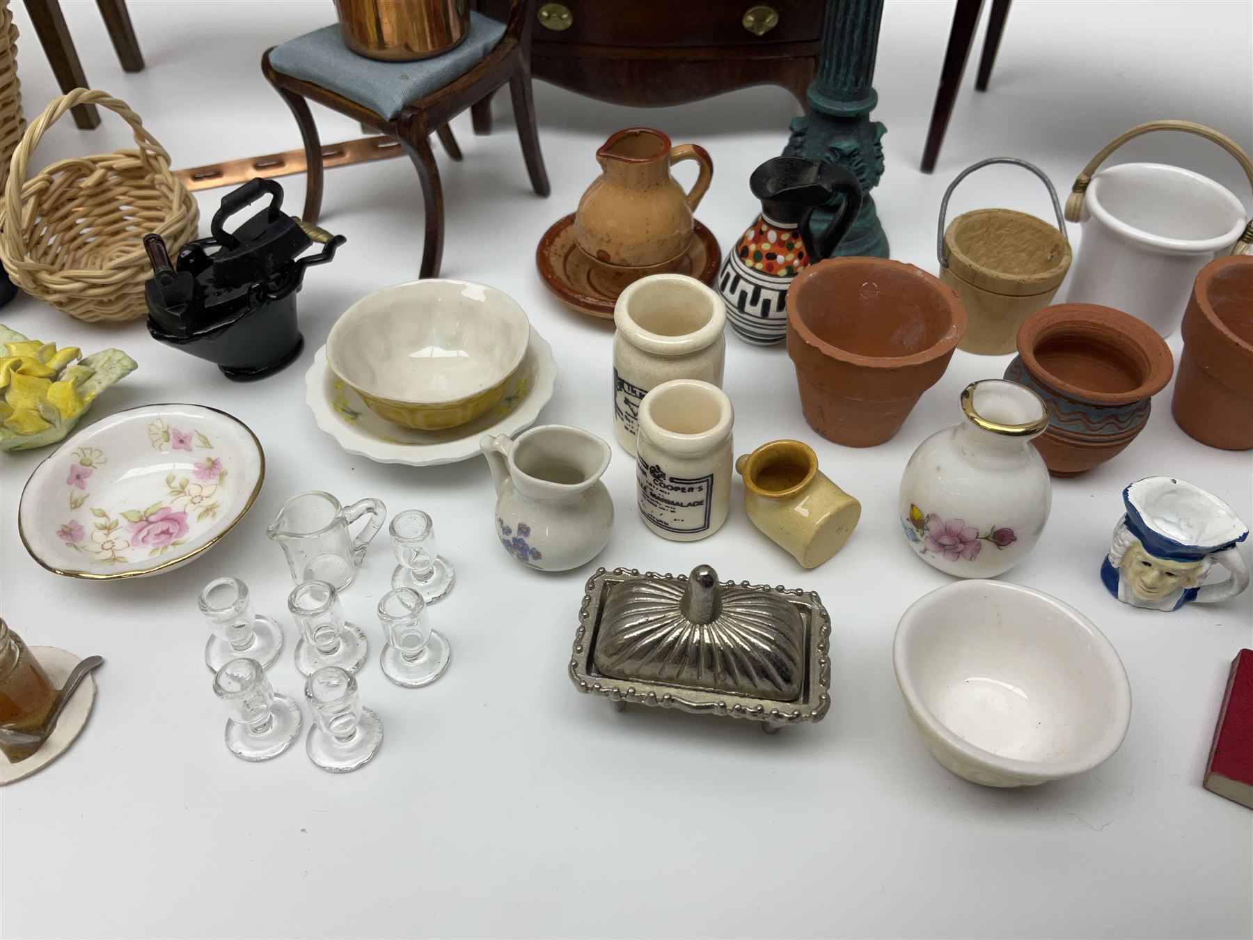 Collection of miniature dolls house furniture and accessories, to include long case clock, chest of drawers, tiled wash stand, ceramics and glass ware, mirror, baskets, etc 
