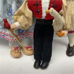 Anna Meszaros Hungary - five hand made needlework figurines including goose girl with stick H20cm; shepherdess in a sitting pose playing a penny whistle with a lamb on her knee; young girl holding a flowerpot; and two others (5)  Auctioneer's Note: Anna Meszaros came to England from her native Hungary in 1959 to marry an English businessman she met while demonstrating her art at the 1958 Brussels Exhibition. Shortly before she left for England she was awarded the title of Folk Artist Master by the Hungarian Government. Anna was a gifted painter of mainly portraits and sculptress before starting to make her figurines which are completely hand made and unique, each with a character and expression of its own. The hands, feet and face are sculptured by layering the material and pulling the features into place with needle and thread. She died in Hull in 1998.