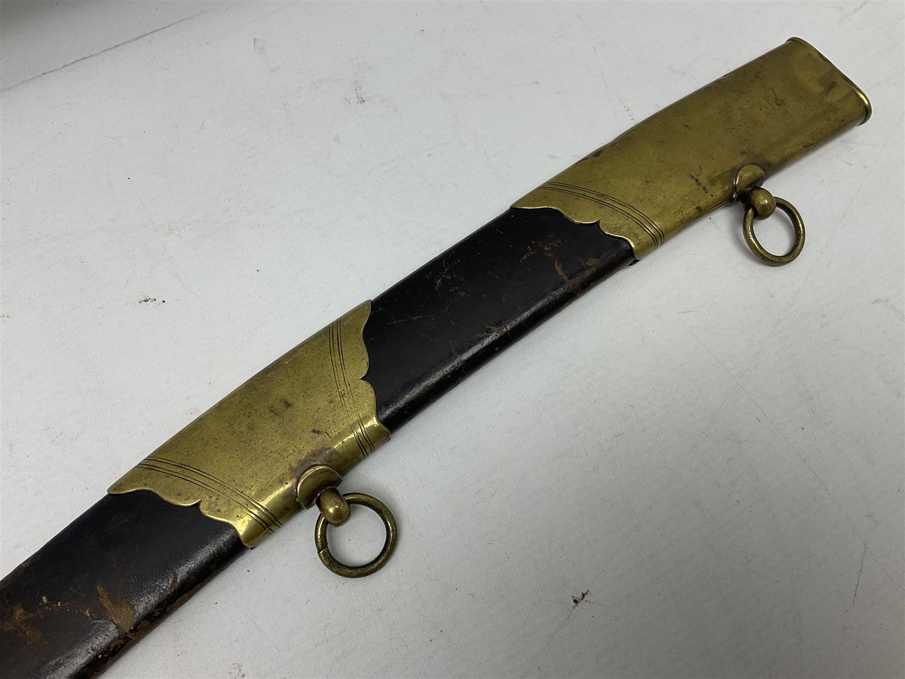 British pattern 1796 Light Cavalry Officer's sword, the 83.5cm curving steel blade marked 'W. Parker London' and 'Warranted' verso, brass stirrup hilt with half-round langets, knucklebow and backstrap with ribbed ivory grip; in brass mounted leather covered scabbard with two suspension rings L97cm overall. This item has been registered for sale under Section 10 of the APHA Ivory Act 