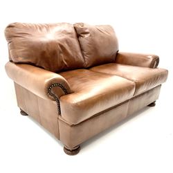Three seat studded tan leather sofa, scrolling arms, turned supports (W190cm) with matching two seat (W155cm) armchair (W100cm) and footstool 