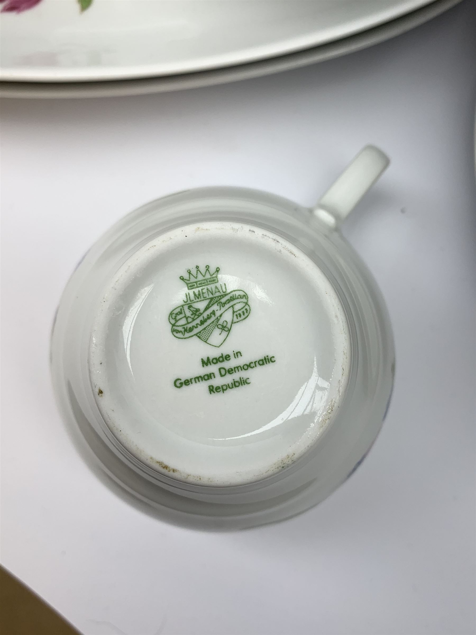 JLmenau German tea and dinner wares, comprising twelve dinner plates, seventeen side plates, twelve bowls, four large serving bowls, pair of oval serving platters, pair of smaller examples, two coffee pots, eleven teacups, twelve saucers, two milk jugs, two larger jugs, and two lidded sucriers. 