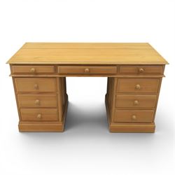 Solid pine twin pedestal desk, fitted with nine drawers, fielded panelled sides