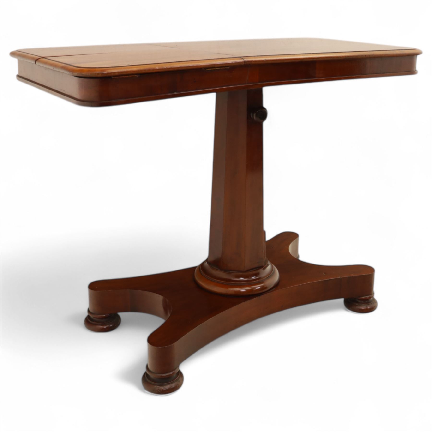 William IV mahogany reading table, the rectangular top with rounded corners and moulded edge, one end fitted with two hinged adjustable reading slops with two rests, the sliding top with a sprung stay mechanism, supported on a single tapered faceted column  with turned collar on a quatreform base with compressed bun feet
