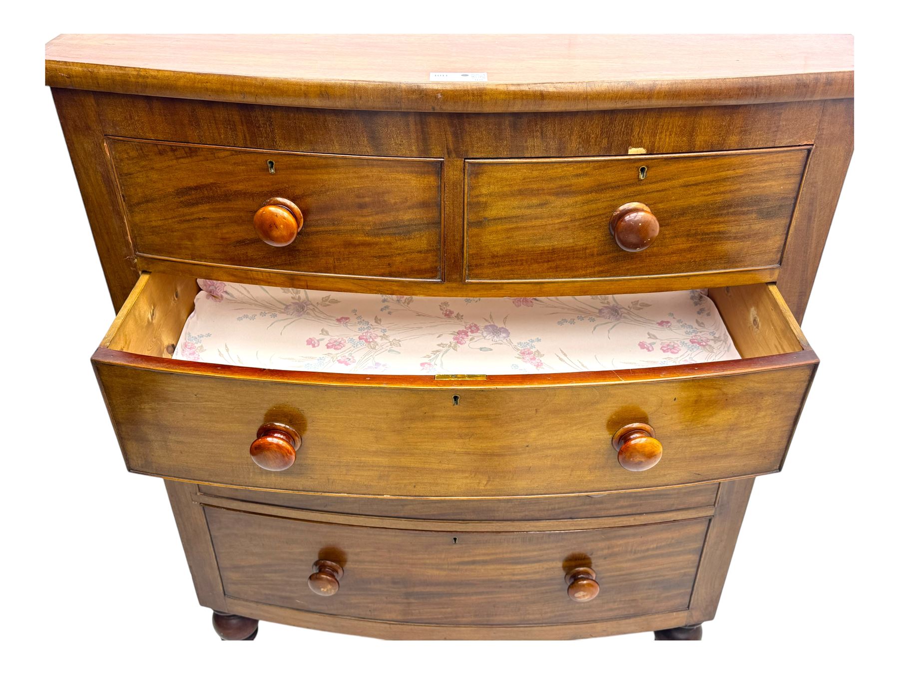 Victorian mahogany bow-fronted chest, fitted with two short over three long graduated cockbeaded drawers, on turned bun supports