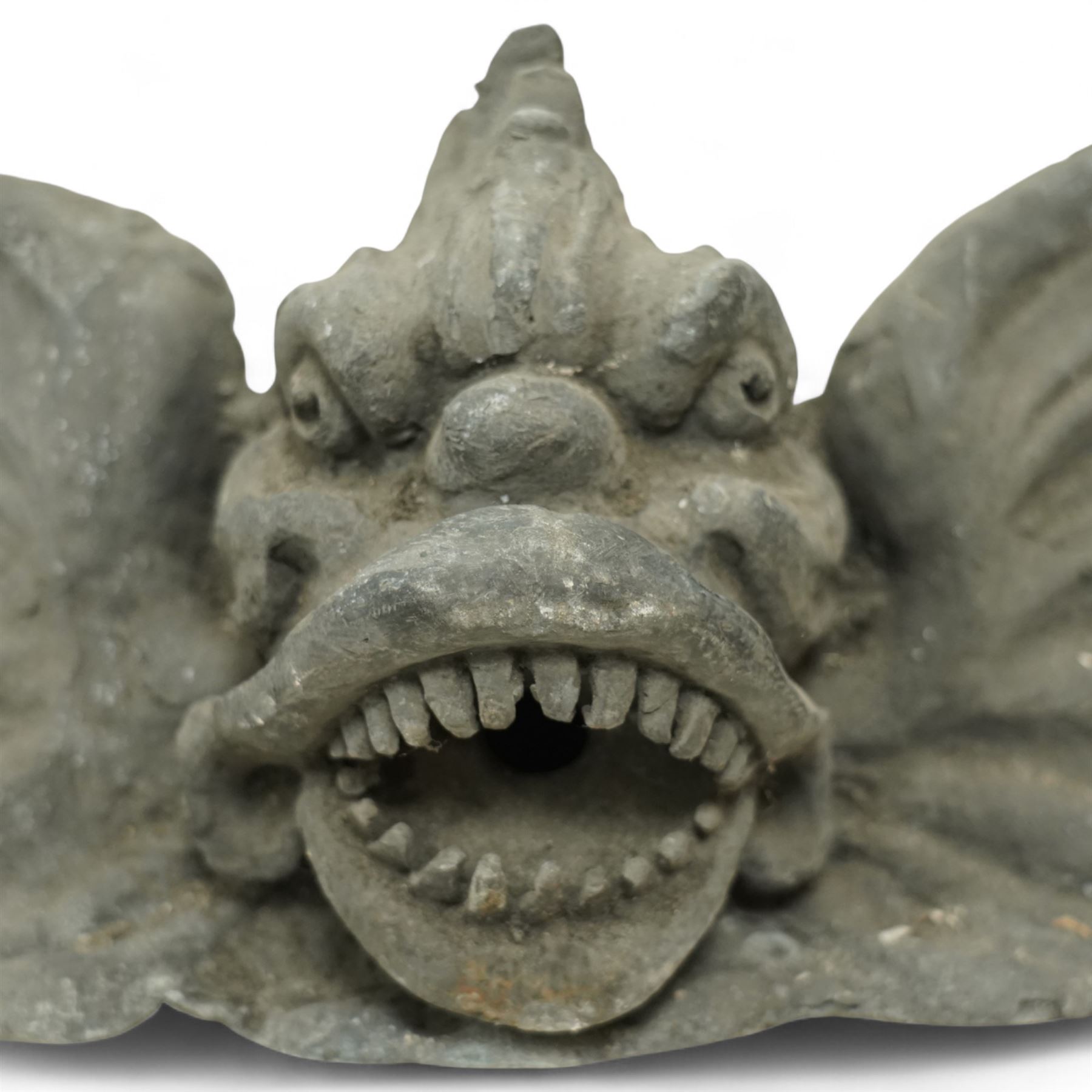 19th century cast lead fountain head with spout in the form of a grotesque fish, the mouth agape with rows of teeth, flanked by protruding fins 
