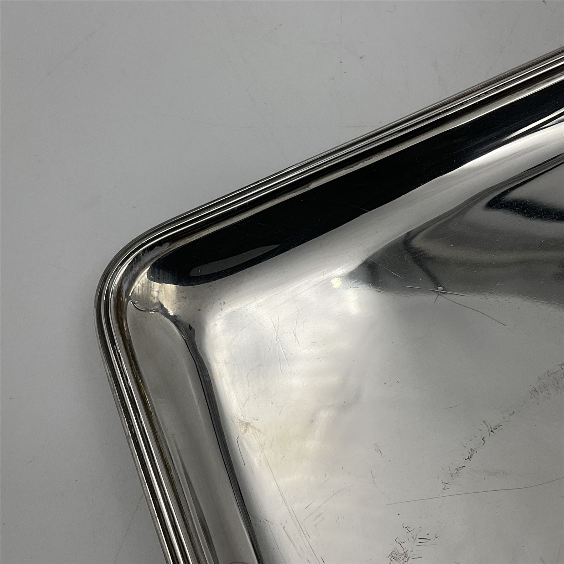 Small early 20th century silver tray, of rectangular form with reeded edge and twin reeded handles, hallmarked Asprey & Co Ltd, London 1914, including handles W26.5cm