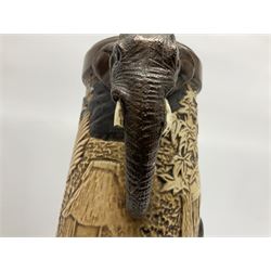 Pair of Bretby vases of tapering cylindrical form decorated with elephants, cranes and fishermen, the bodies with twin elephant mask handles, with coppered borders, raised upon three bun feet, stamped Bretby 2246 marks beneath, H32cm