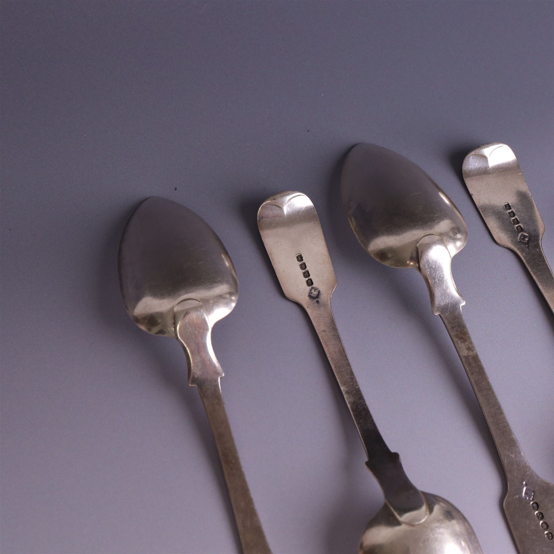 Set of four George III silver Fiddle pattern table spoons all engraved with monogram, hallmarked Thomas Wallis (II) & Jonathan Hayne, London 1819, together with a  Victorian silver Fiddle pattern teaspoon with engraved initials, hallmarked William Rawlings Sobey, Exeter 1846