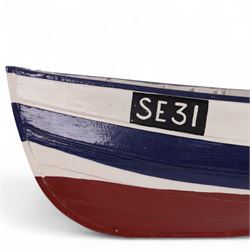 Two wooden fishing coble models, comprising SE31, with rudder, painted in blue, white and red and SSS.33 'Alice', painted in green, black and yellow, largest H16cm, L70cm