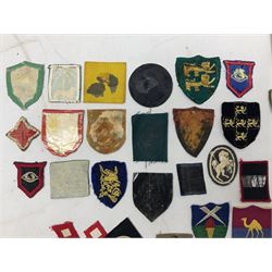 Approximately one-hundred printed and embroidered cloth badges including Royal Tank Regiment, Royal Armoured Corps, 219th Independent Infantry Brigade, Cyrenaica, Cyprus, Singapore and other districts, Gibraltar Garrison, East Anglian Brigade, 20th Armoured Brigade and various armoured divisions etc