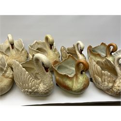A large quantity of assorted sized ceramic planters modelled as swans. 