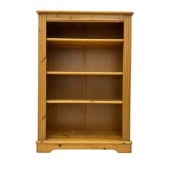 Pine open bookcase, fitted with four adjustable shelves, fluted uprights, on bracket feet 