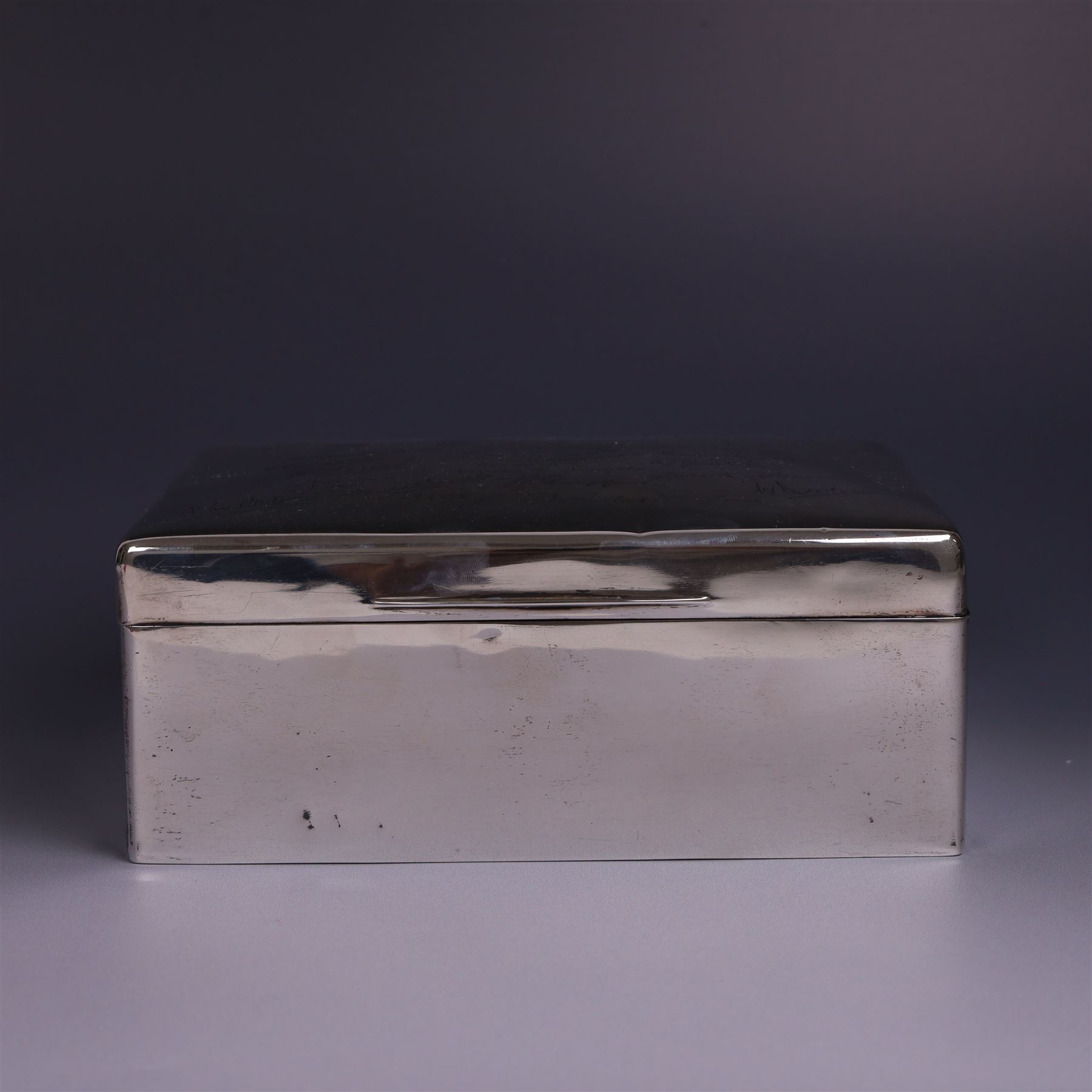 WWII silver mounted cigarette box, of rectangular form, the hinged cover inscribed 'presented to Major & Mrs James Bennett on the occasion of their marriage by the officers of the Liverpool Wardens Service October 1944' and engraved with twenty-four signatures of the officers, with softwood interior, hallmarks worn and indistinct, H7.5cm, W19cm