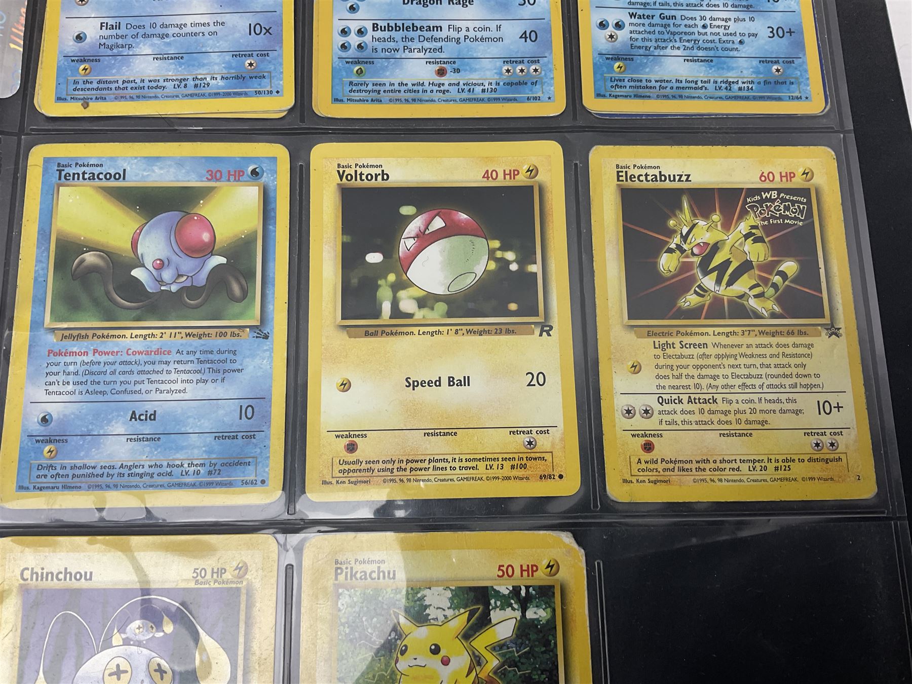 Collection of Pokemon trading cards, mostly 1999 Wizards Pokemon cards to include holo Charizard 4/102, first edition holo Machamp 8/102, further holographic cards; Dark Flareon 35/82 and Dark Vaporeon 45/82, cards from themed sets and 4th edition prints; 1998 Electronic Pokédex with cardboard boxes for themed decks Blackout, Overgrowth and Power Reserve Jungle, along with a large quantity of energy and trainer cards 