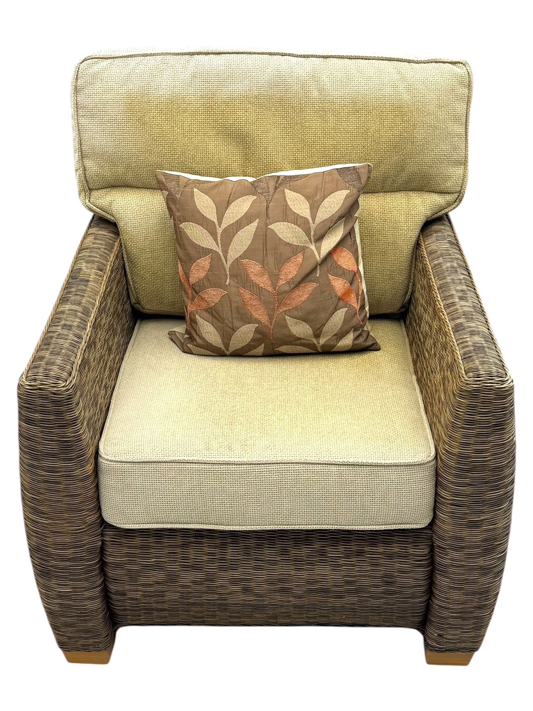Contemporary two seat rattan conservatory sofa with loose cushions, and pair of matching armchairs, with upholstered seat and back cushions in a beige fabric, curved arms and front complete with scatter cushions 

Chairs (H 92cm, W 75cm, D 84cm)
Sofa (H 92cm, W 130cm, D 84cm)