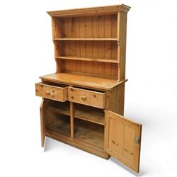 Traditional pine kitchen dresser, the open rack with three shelves beneath a moulded top, over a base fitted with two drawers and a pair of panelled cupboard doors, the whole raised on a moulded base
