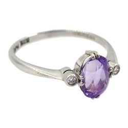 Early 20th century three stone oval amethyst and diamond chip ring, stamped 18ct Plat