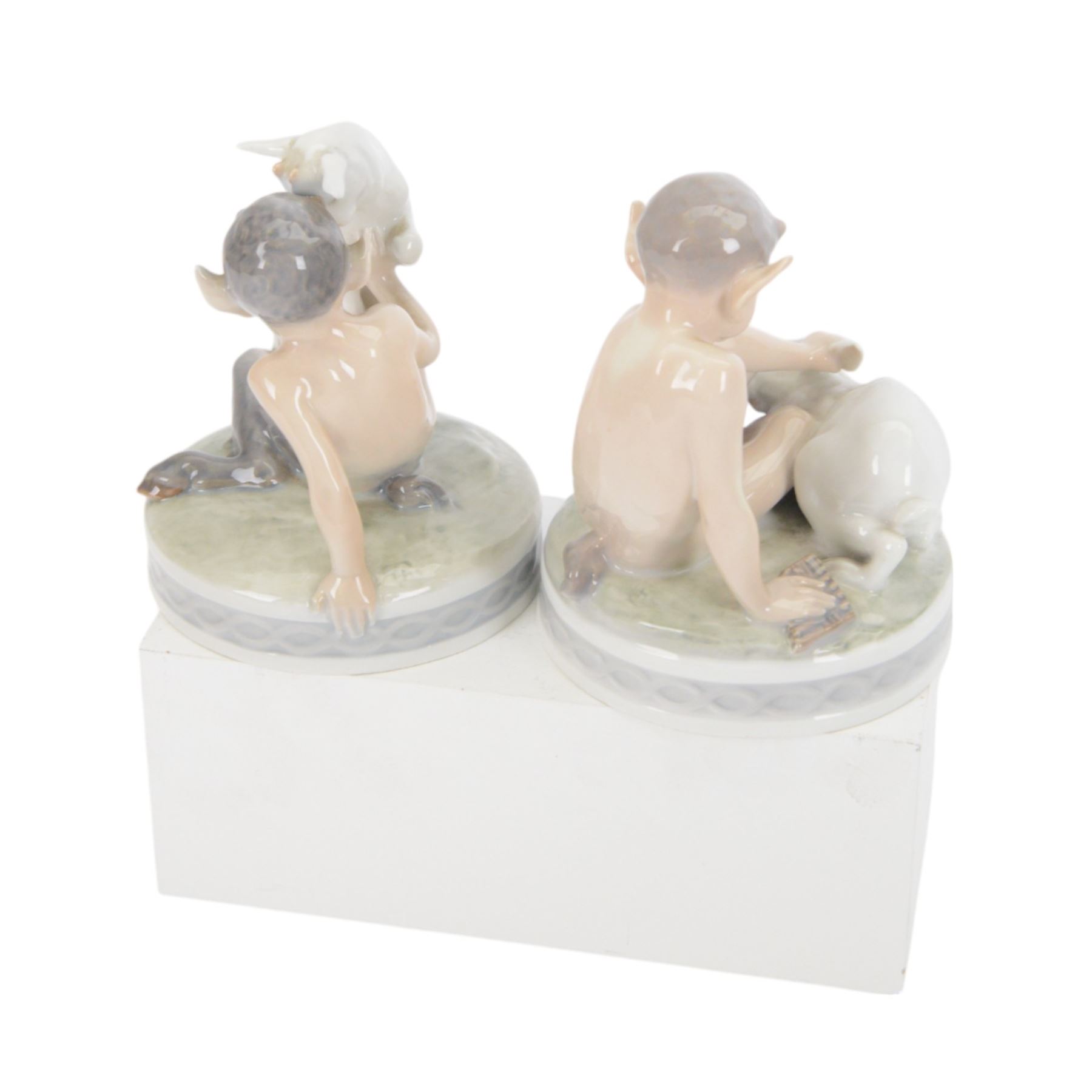 Four Royal Copenhagen figures, comprising Faun with Goat no 498, Faun with Rabbit no 439 and two faun riding on tortoise going fast no 858